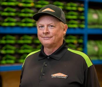 Jeff is a white male wearing a black servpro hat and a black servpro polo